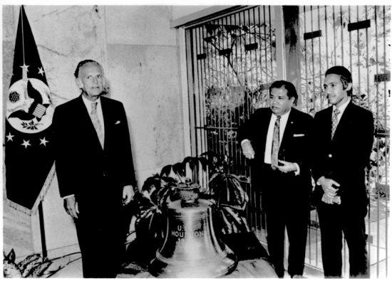 A black and white image of the handover of the USS Houston bell.