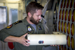 Leading Seaman Aircrew Ivan Plavsic loads sonar buoys into HMAS Parramatta's embarked MH-60R Seahawk Romeo helicopter, during Exercise Ocean Explorer 17.