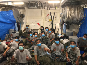 Indonesian fishermen rescued in the Indian Ocean are accommodated on HMAS Anzac's quarterdeck.