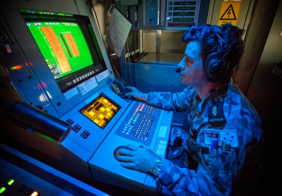 Able Seaman Combat Systems Operator - Mine Warfare, Duncan Cobb, monitors the sonar picture in HMAS Huon's Operations Room during the Mine Counter Measures and Diving Exercise 2014.