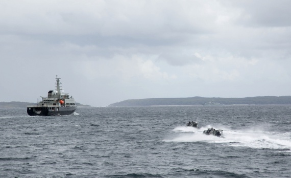 HMAS Toowoomba's boarding party approach the training ship MV Sycamore during a boarding drill as part of Exercise OCEAN EXPLORER 2018.