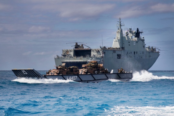 A Royal Australian Navy Landing Craft transports Australian Army Armoured Personnel Carriers from HMAS Adelaide to Cowley Beach, during exercises in Queensland.