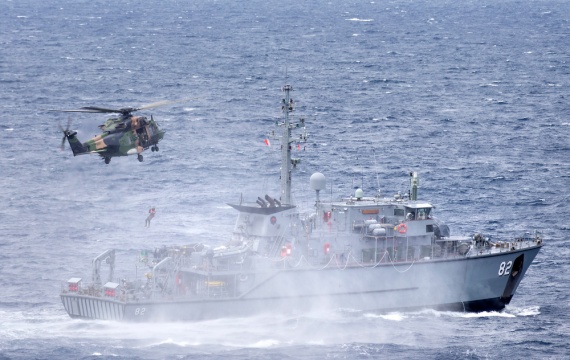 HMAS Choules' embarked MRH-90 Taipan helicopter, call sign “Hat Trick”, conducts passenger transfer serials with HMAS Huon during the ship’s transit to Vanuatu.
