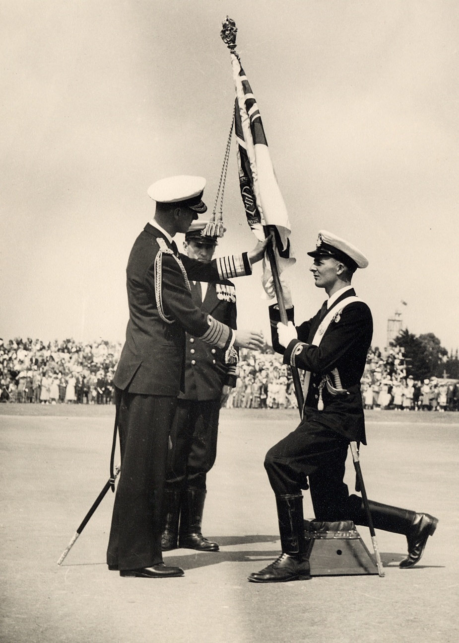 Lieutenant John Forbes RN (later Vice Admiral) accepts the Sovereign’s Colours from the Duke of Edinburgh, HRH Prince Philip during a ceremony at Flinders Naval Depot in 1954. (Forbes Collection)