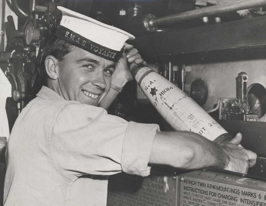Able Seaman Brian Miller handling a 4.5-inch shell in one of Voyagers gun bays