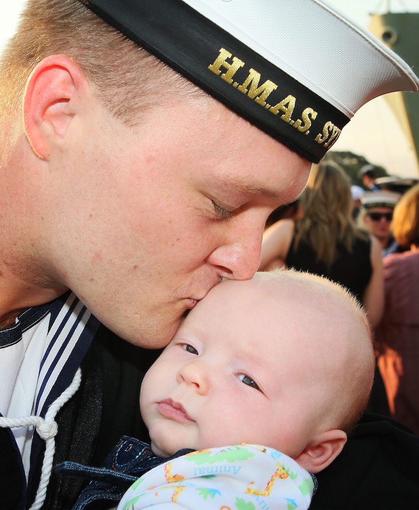 Able Seaman Mathew Avery with his 14 week old son Riley, at the welcome home ceremony for HMAS Sydney in Sydney after five months away on Northern Trident.