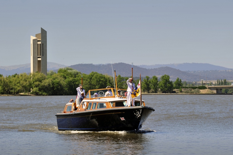 Her Majesty Queen Elizabeth II is ferried across Lake Burley Griffin in Canberra during the 2011 Royal Visit. Note the presence of her personal flag flying in the bows of the royal barge.