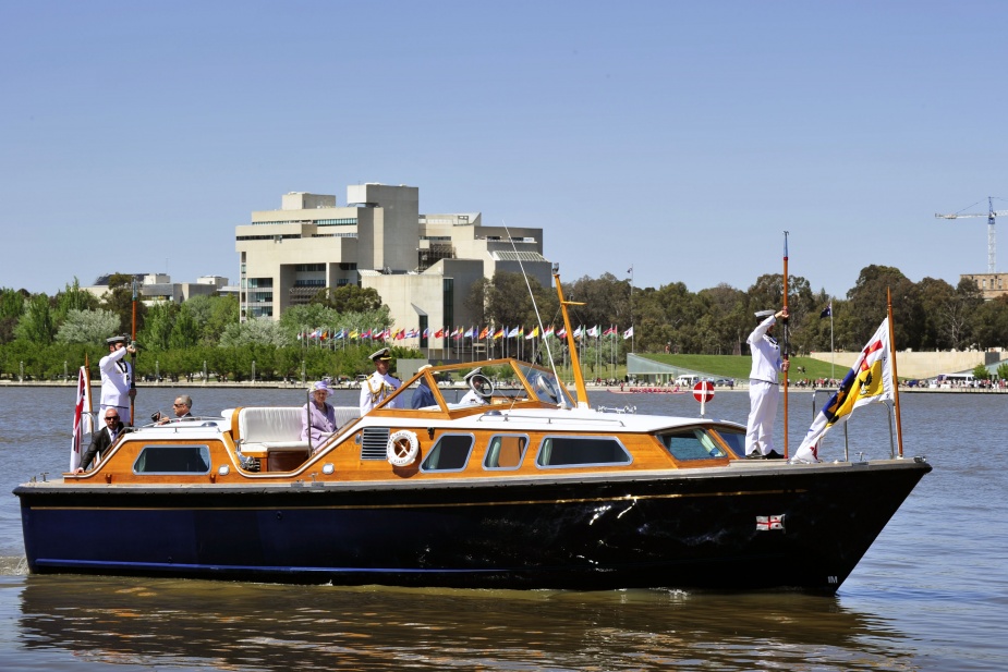 Her Majesty Queen Elizabeth II is ferried across Lake Burley Griffin in Canberra during the 2011 Royal Visit. Note the presence of her personal flag flying in the bows of the royal barge.