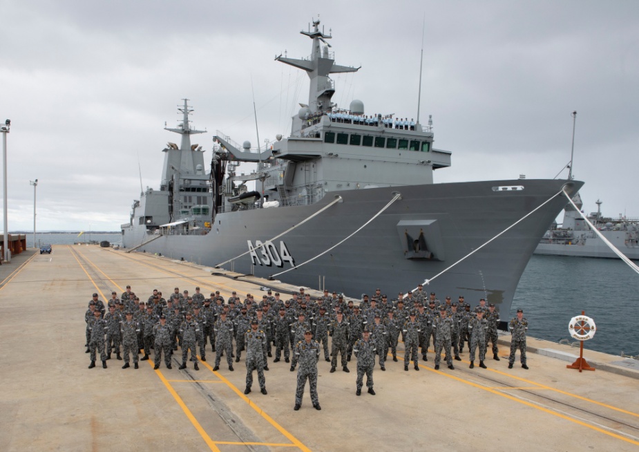 The crew of NUSHIP Stalwart gathers in front of their ship for the first time, alongside Navantia crew on the ship's bridge, at Fleet Base West in Western Australia, June 2021.