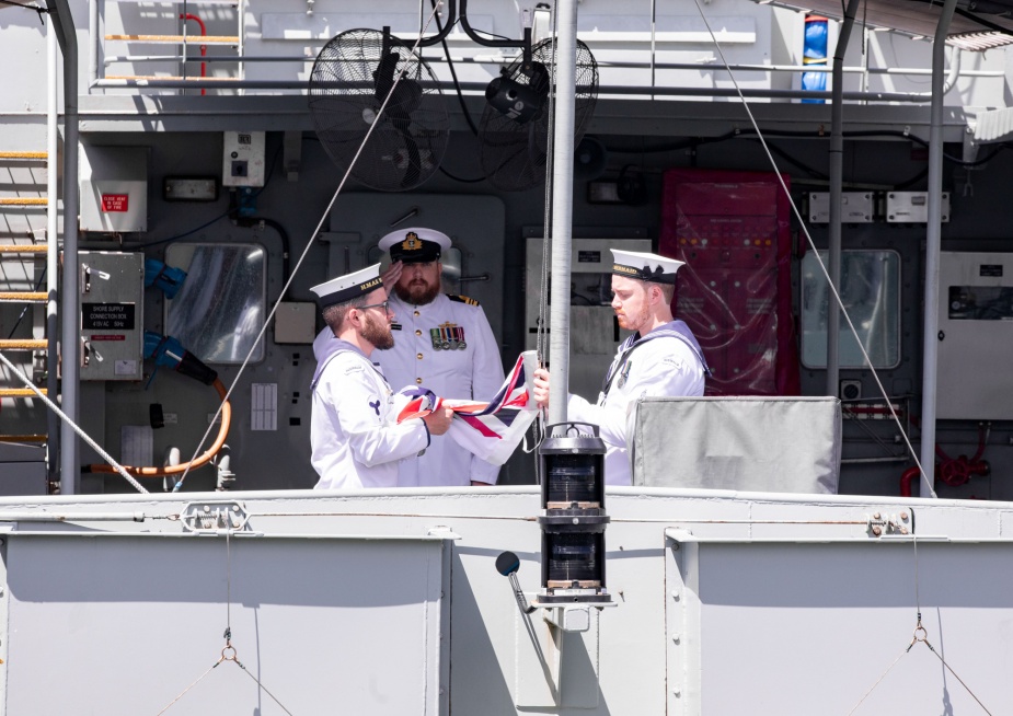 The Australian White Ensign is lowered for the final time during Mermaid's decommissioning ceremony on 18 September 2021.