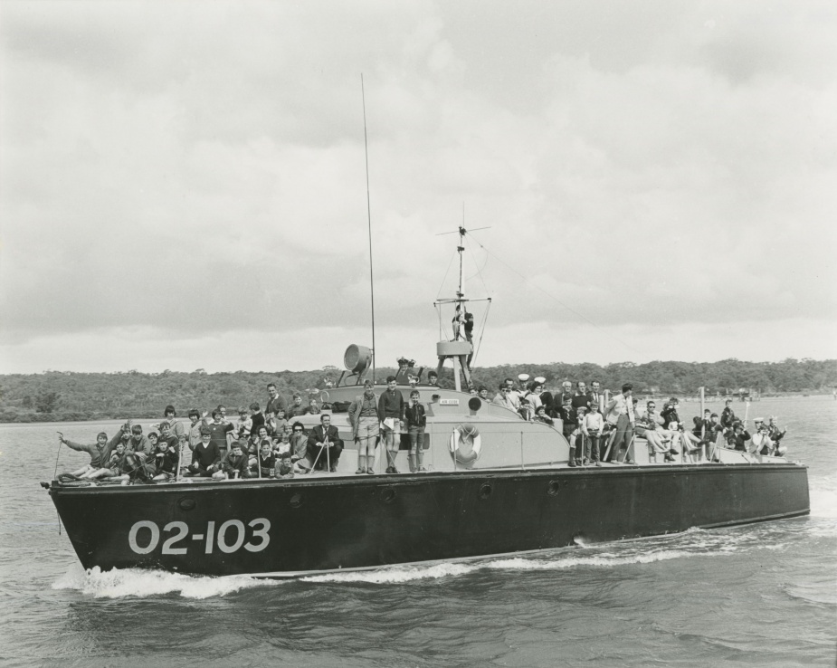 Children and their families enjoying a pleasure cruise on-board HMAS Air Guide. 