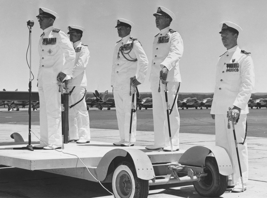 Vice Admiral Sir Roy Dowling RAN addresses the assembled guests during an inspection of HMAS Albatross. Also present is Rear Admiral Hastings Harrington, Lieutenant Commander Andrew Robertson and Captain Victor Smith. (Robertson collection)