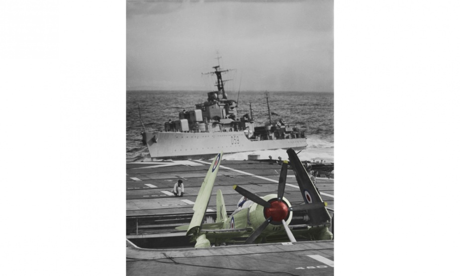 HMAS Sydney prepares to raise and make ready a Sea Fury for launch while Anzac takes up recue destroyer station astern.