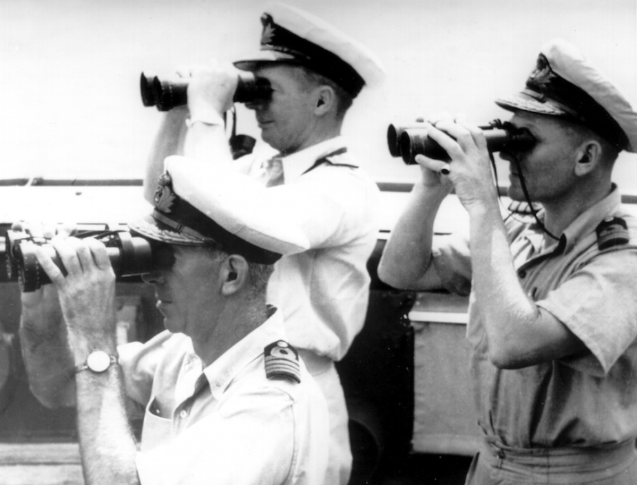 Commodore Collins, Captain Dechaineux and Commander Gatacre on the compass platform of HMAS Australia. Dechaineux was killed and Collins badly injured when a Japanese suicide aircraft struck the bridge on 21 October 1944.