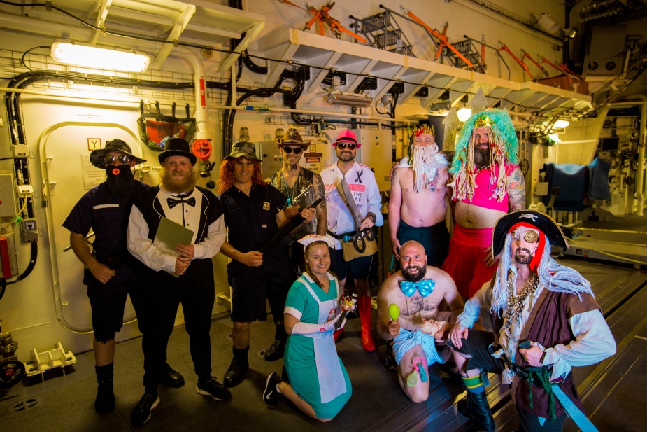 Members of HMAS Hobart (III) portray the Royal Court during a crossing the line ceremony in 2018.