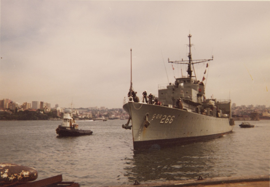 Diamantina prepares to come alongside Garden Island, Fort Denison can be seen in the background. c. 1977.