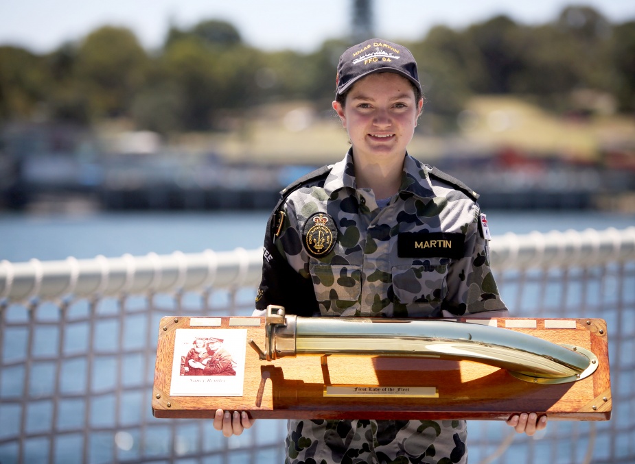 Seaman Combat Systems Operator Ashley Martin holds the First Lady of the Fleet Trophy, which was first awarded to HMAS Darwin in 2017.