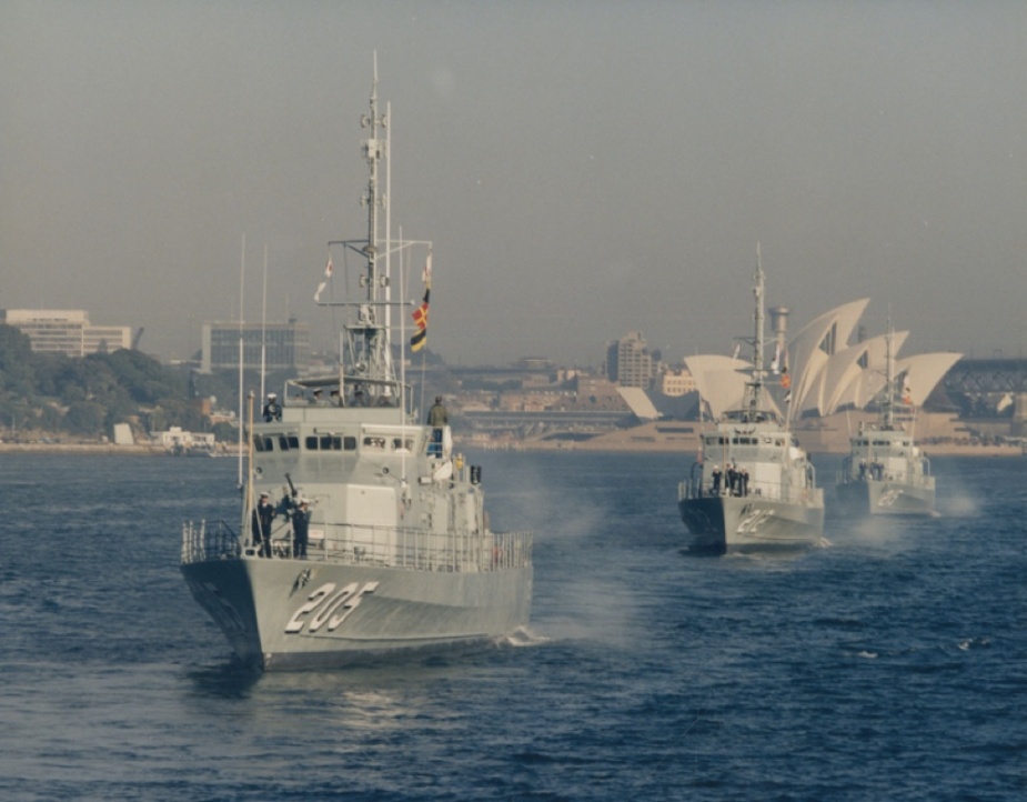 HMAS Townsville, HMAS Gawler and HMAS Geelong passing the Sydney Opera house in column.