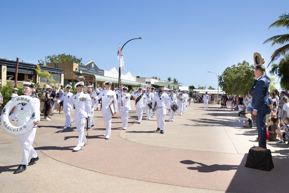 Exmouth Shire President, Matthew Niikkula (right) doffs his hat as HMAS Gascoyne's Ship's Company and Royal Australian Navy Band's Western Australia detachment conduct a Freedom of Entry March through the streets of Exmouth in Western Australia. October 2021