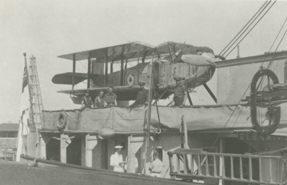 A Fairey IIID seaplane, and its RAAF aircrew and maintainers embarked in HMAS Geranium for survey operations in the Great Barrier Reef in 1924.