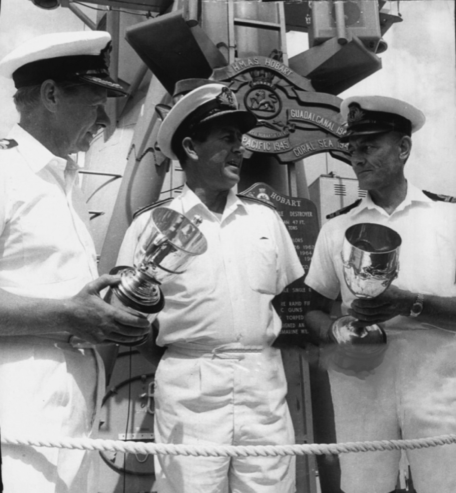 Rear Admiral H.D. Stevenson, Flag Officer Commanding the Australian Fleet, presents the Duke of Gloucester Cup and the Commodore Wardle Cup to HMAS Hobart in recognition of stellar service. 1970