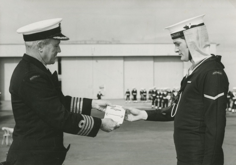 Naval Airman David Benge is presented with his SAR Divers wings by Captain JD Goble, Commanding Officer HMAS Albatross, circa 1961.