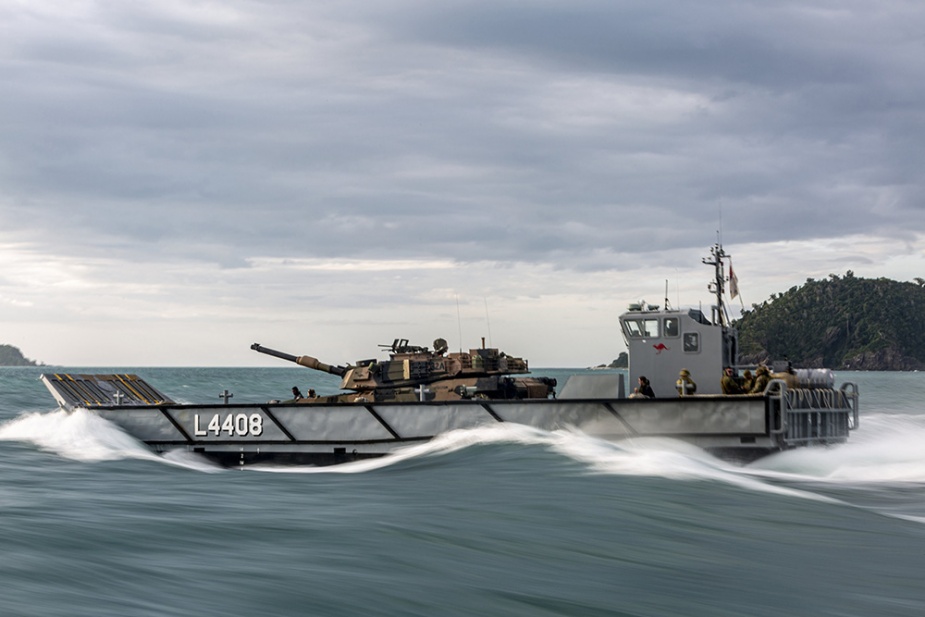 A Royal Australian Navy Light Landing Craft transports an Australian Army M1A1 Abrams main battle tank as part of load trials onboard HMAS Canberra.