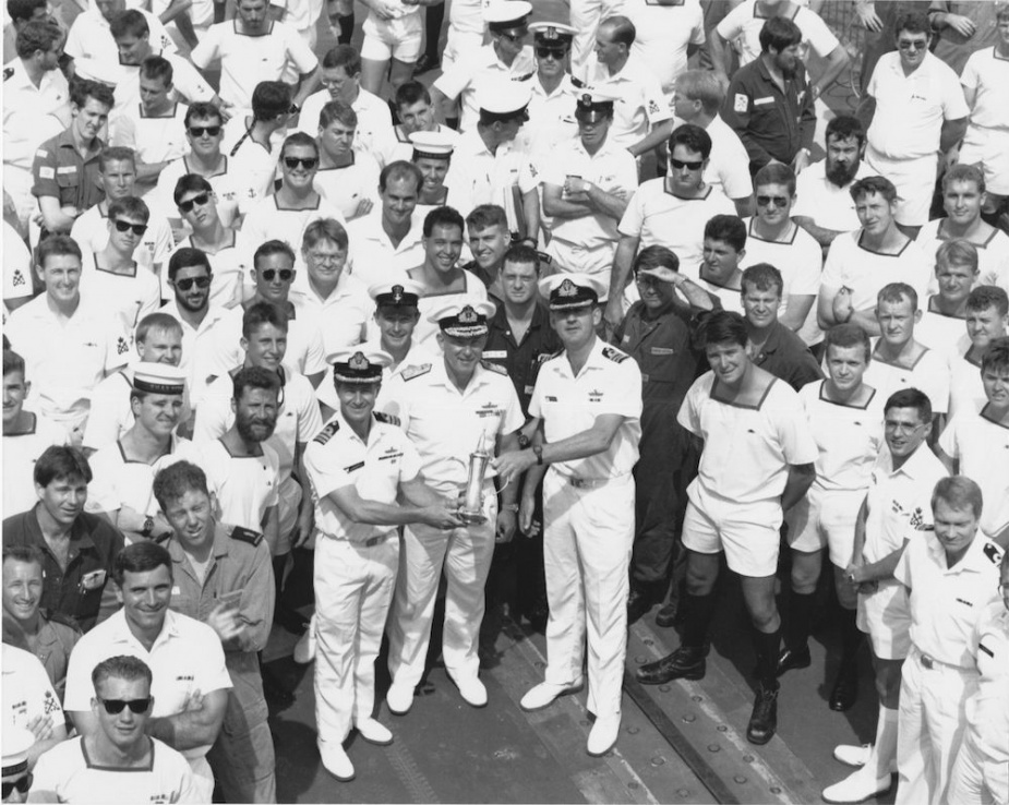 Sydney's Commanding Officer Commander Lee Cordner receives 'the weight' from Commander Martyn Bell (HMAS Darwin) during a handover ceremony in Darwin prior to the ship's deployment for Operation DAMASK IV. The Fleet Commander Rear Admiral RAK Walls, RAN also took the opportunity to farewell Sydney and welcome Darwin home.