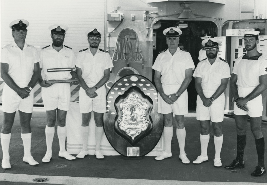 Commanding Officer HMAS Adelaide (II) Captain A.M. Carwardine and his charges proudly present the Otranto Shield earnt by the ship in 1984.