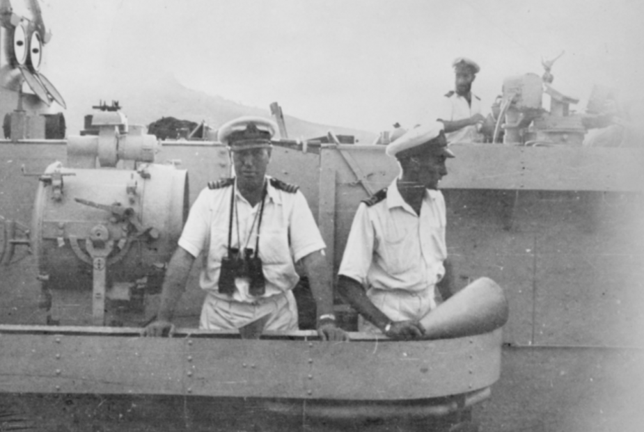 Commander William Marks DSC RAN (left), Lieutenant Dacre  Smyth RAN (right) and Lieutenant Patrick  Burnett RAN (in background on the compass platform) standing on the wings of the bridge of HMAS Bataan as the ship slips from alongside a depot repair ship in the port of Kure, Japan, to take part in the US-led landing at Inchon. (AWM collection)