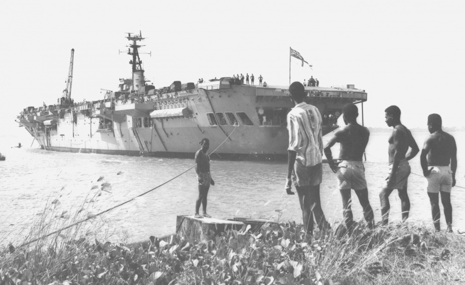 Sydney moored at Manus Island with cargo embarked.