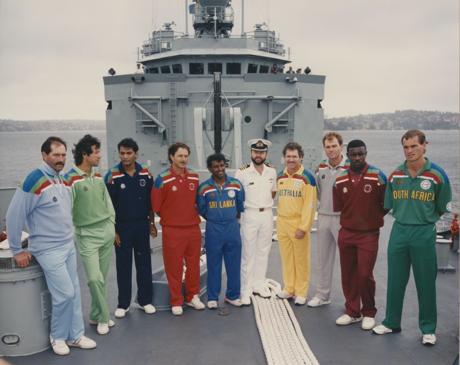 In February 1992 Canberra was host to the World Series Cricket squads in Sydney Harbour. Seen here is Commander R.W. Gates, RAN posing with the captains of each squad.