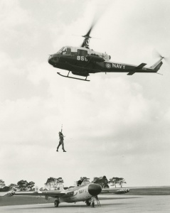 An RAN Iroquois conducts rescue training at NAS Nowra, flying over a Sea Venom.