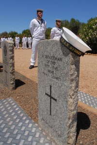 HMAS Sydney (IV) sailors at the Geraldton War Cemetery with the headstone of the unknown serviceman.