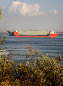 HMAS Adelaide (III) enters Port Phillip Bay for the first time on MV Blue Marlin.