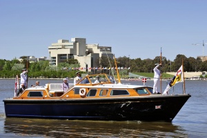 Her Majesty The Queen and The Duke of Edinburgh aboard the Admiral"s Barge as it comes in to dock at Regatta Point near the Floriade site in Canberra.