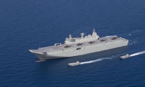 HMAS Canberra off the north Queensland coast with 5 MRH 90 aircraft on deck and her four Landing Craft deployed.