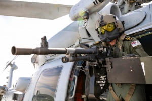 Petty Officer Aircrew Raymond Solomon conducts pre-flight inspections of a Mag 58 machine gun on the Seahawk MH-60R helicopter embarked on HMAS Parramatta.